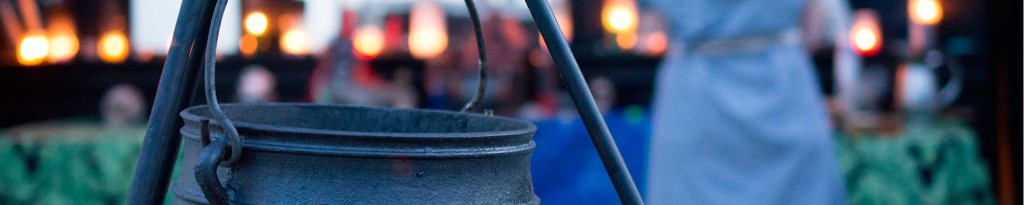 Decorative image of a cauldron hanging from a stand for ritual