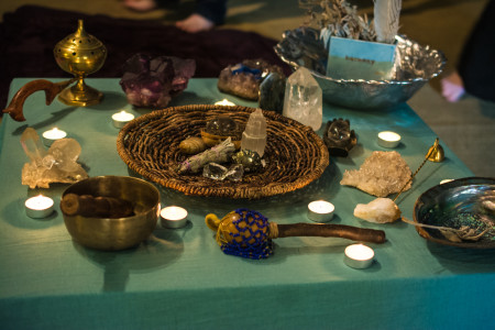 Ritual implements displayed on a table with tea light candles