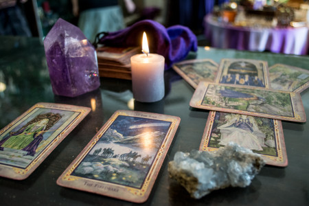 Tarot cards on a table with a crystal and a candle