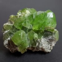 Example of raw peridot - a green stone that isn't as clear as its faceted counterpart