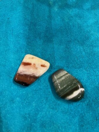 Examples of red and green sardonyx. The red version is striped with white and shades of red, and the green version is striped with white and shades of green