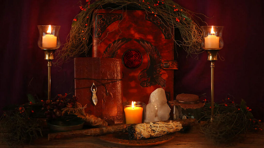 a person's altar with candles and books