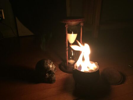 A skull and hourglass on a wood floor