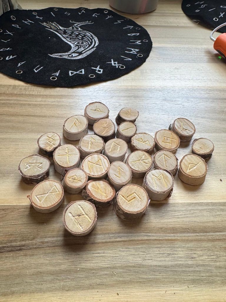 A group of round wooden runes on a table
