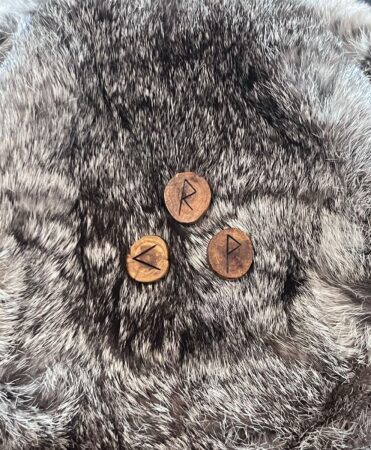 A group of round wooden runes on a furry surface