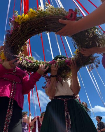 A group of people holding a wreath of flowers