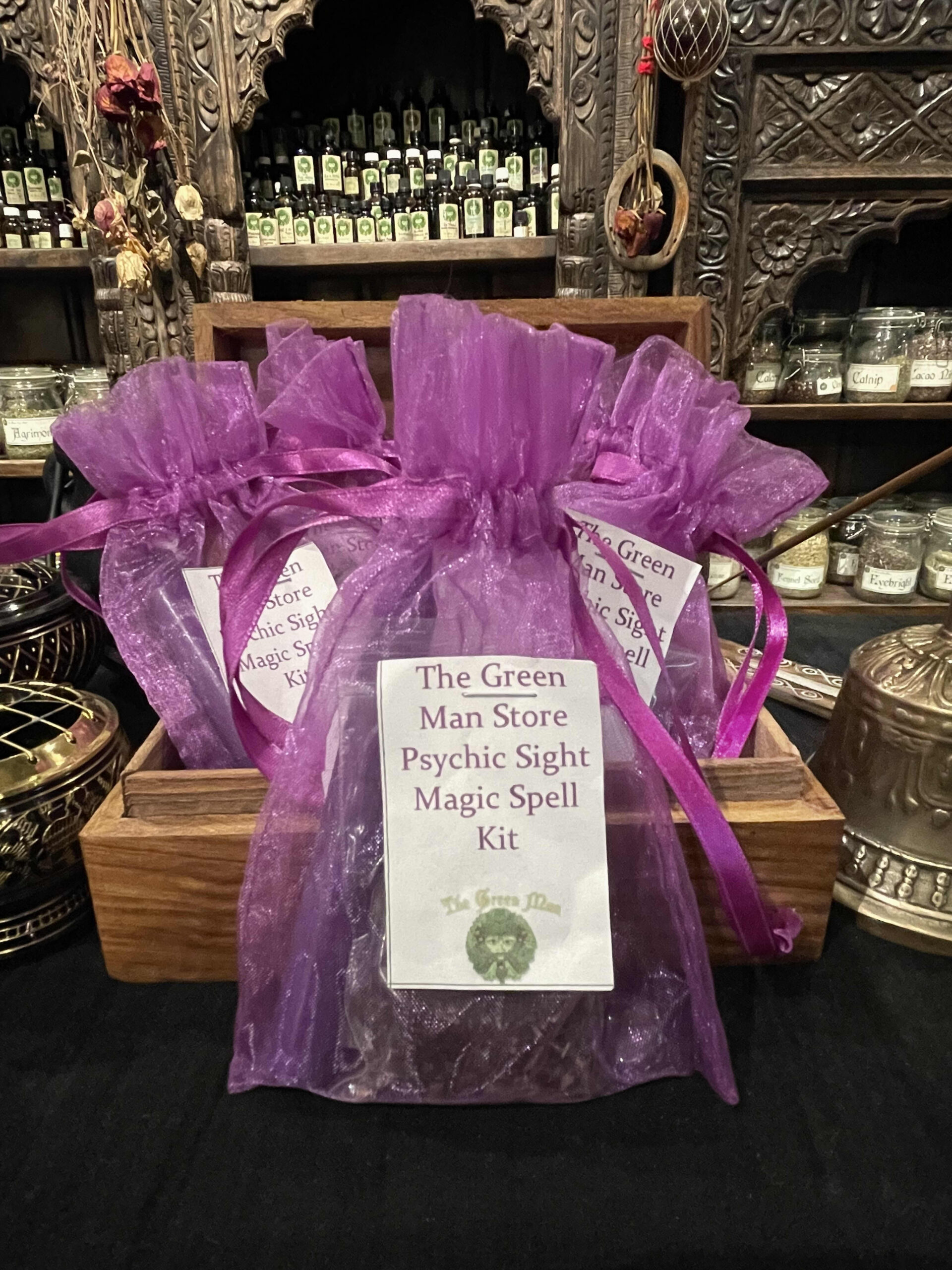 A group of purple bags with white labels in a wooden box